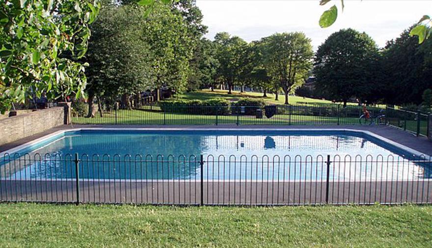 Children's paddling pool surrounded by trees